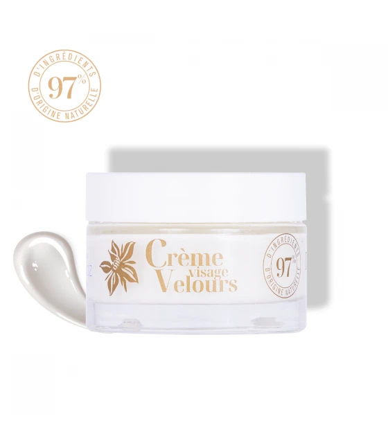 A jar of 'Crèmeissant Velours' velvet face moisturizer moisturizing face cream with a label indicating it is 97% natural. The jar is white with gold accents and the cream inside is visible, showing a light texture.